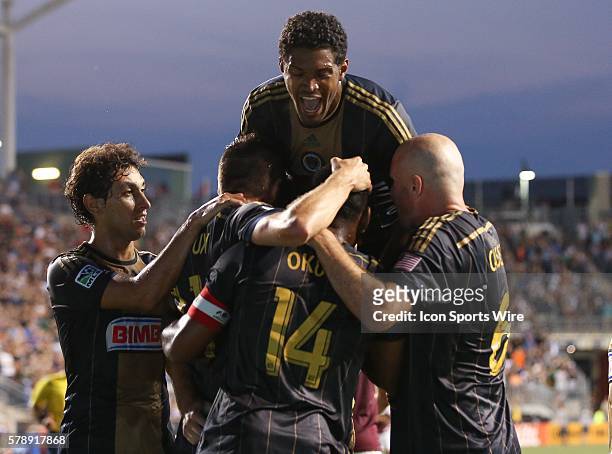 Philadelphia Union defender Sheanon Williams leaps on top of the pile in celebration of a Union goal in a Major League Soccer match against the...