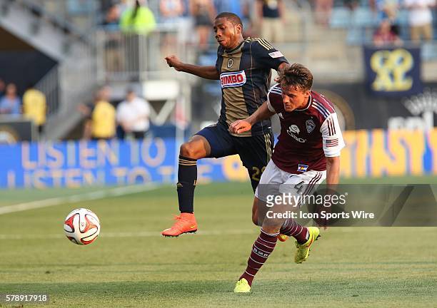 Philadelphia Union defender Raymon Gaddis and Colorado Rapids defender Marc Burch compete for the ball in a Major League Soccer match at PPL Park in...