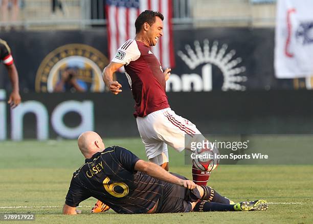 Philadelphia Union forward Conor Casey slides tackles the ball from Colorado Rapids forward Kamani Hill in a Major League Soccer match at PPL Park in...