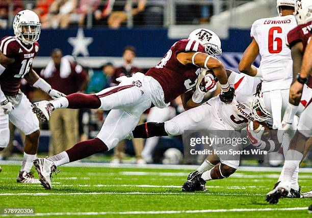 Texas A&M Aggies linebacker Shaan Washington tackles Arkansas Razorbacks running back Alex Collins during the game between the Texas A&M Aggies and...