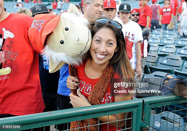 An Angels fan in the stands with her monkey before ALDS game one between the Los Angeles Angels of Anaheim and the Kansas City Royals played at Angel...