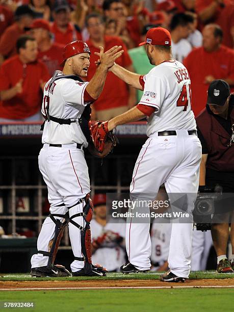 Los Angeles Angels of Anaheim catcher Chris Iannetta and pitcher Kevin Jepsen react after getting out of the tenth inning during game one of the ALDS...