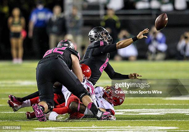 Oregon Ducks quarterback Marcus Mariota tries to toss the ball as he is being tackled during the game between the Arizona Wildcats and the Oregon...