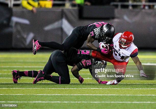 Arizona Wildcats running back Terris Jones-Grigsby is tackled by Oregon Ducks linebacker Derrick Malone as Oregon Ducks defensive back Ifo...