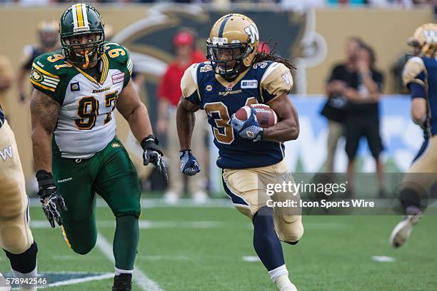 July 2014 Eskimos Eddie Steele chases Blue Bombers Nic Grisby during the Eskimos vs Bombers game at the Investors Group Field in Winnipeg MB.