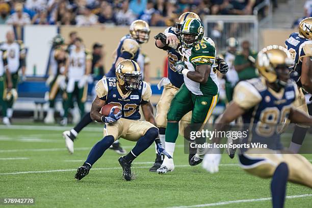 July 2014 Blue Bombers Nic Grisby is chased by Eskimos Gregory Alexandre during the Eskimos vs Bombers game at the Investors Group Field in Winnipeg...