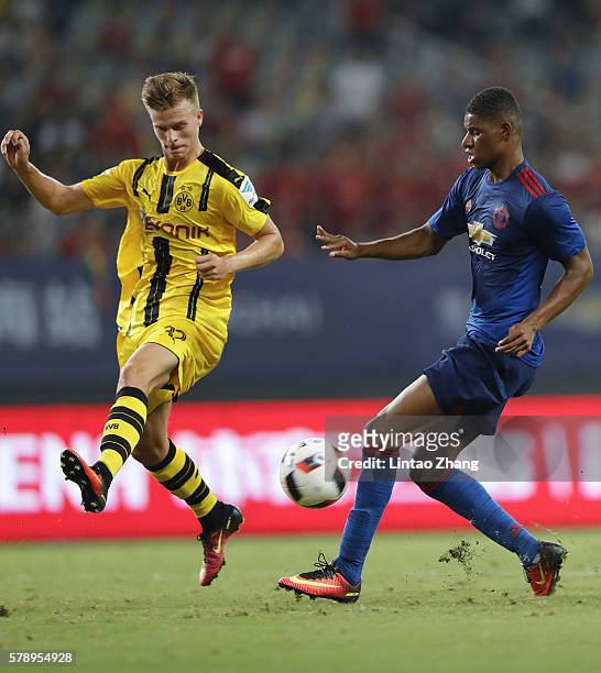Marcus Rashford of Manchester United competes for the ball with Felix Passlack of Borussia Dortmund during the International Champions Cup match...