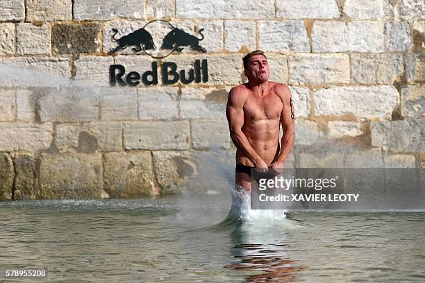 Artem Silchenko hits the water after diving from the 27.5 metre high platform on the Saint-Nicolas tower during the Red Bull Cliff Diving World...