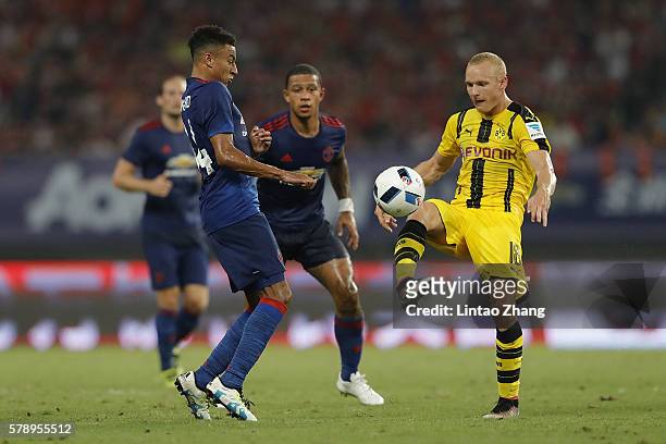 Jesse Lingard of Manchester United competes for the ball with Sebastian Rode of Borussia Dortmund during the International Champions Cup match...