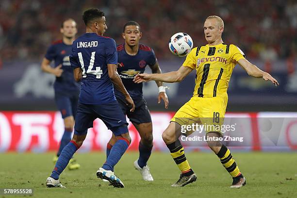 Jesse Lingard of Manchester United competes for the ball with Sebastian Rode of Borussia Dortmund during the International Champions Cup match...