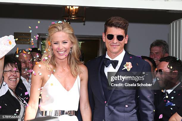 Bridegroom Mario Gomez and his wife Carina Wanzung during their wedding at registry office Mandlstrasse on July 22, 2016 in Munich, Germany.