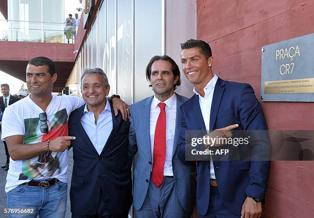 Portuguese forward Cristiano Ronaldo poses with his brother Hugo Aveiro , owner and chairman of Pestana Hotel Group, Dionisio Pestana and the...