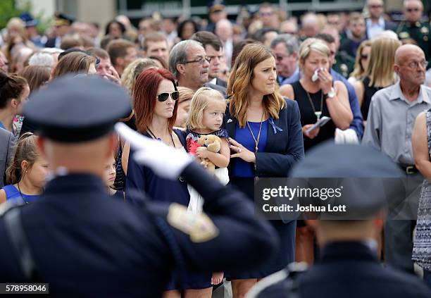 Dechia Gerald holds her daughter as she attends the funeral of her husband, Baton Rouge Police Officer Matthew Gerald, at Healing Place Church Arena...