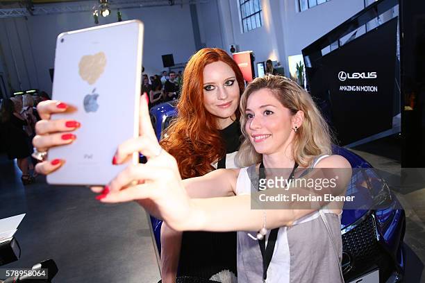 Barbara Meier and a guest are taking selfies during the Breuninger show during Platform Fashion July 2016 at Areal Boehler on July 22, 2016 in...