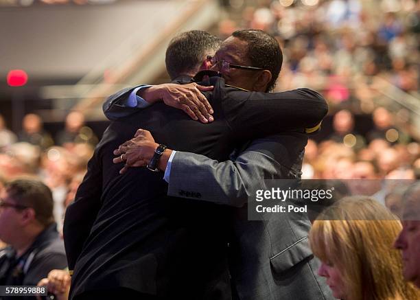 Baton Rouge Mayor Kip Holden, right, hugs Baton Rouge Police Chief Carl Dabadie, Jr., during funeral services for Baton Rouge police officer Matthew...