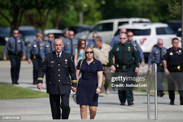 Police officers arrive for the funeral of Baton Rouge Police Officer Matthew Gerald at Healing Place Church Arena on July 22, 2016 in Baton Rouge,...