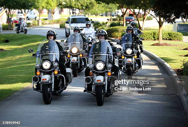 Police officers arrive for the funeral of Baton Rouge Police Officer Matthew Gerald at Healing Place Church Arena on July 22, 2016 in Baton Rouge,...