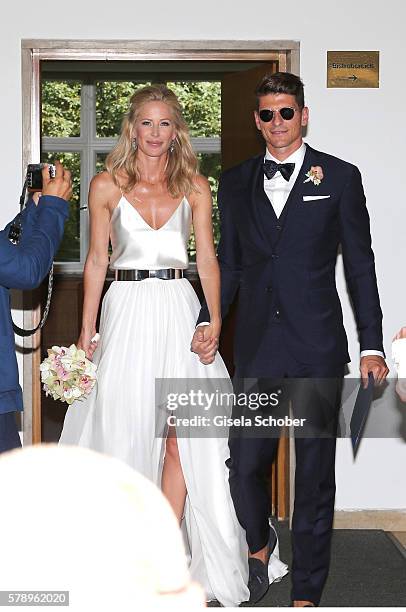 Bridegroom Mario Gomez and his wife Carina Wanzung during their wedding at registry office Mandlstrasse on July 22, 2016 in Munich, Germany.