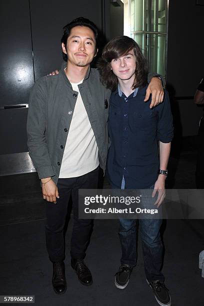 Actors Steven Yeun and Chandler Riggs attend AMC's "The Walking Dead" panel during Comic-Con International 2016 at San Diego Convention Center on...