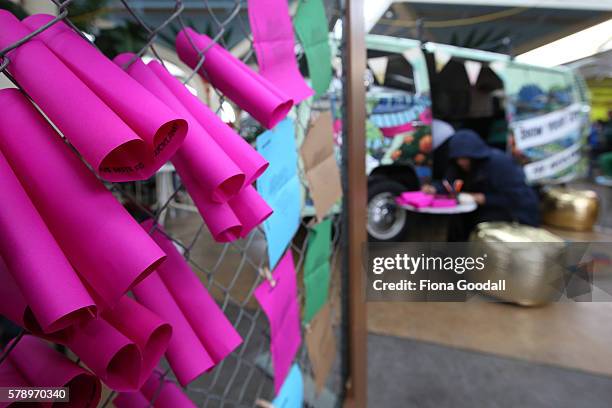 People write love notes to Auckland outside the Love Bus parked in Mangere Town Centre on July 23, 2016 in Auckland, New Zealand. The van is part of...