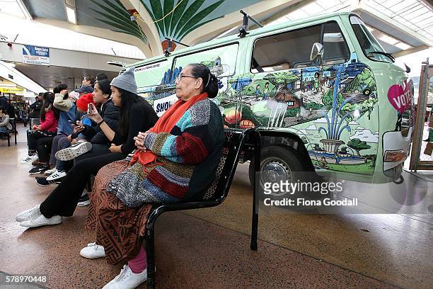 Mele Leota watches the entertainment in front of the Love Bus parked in Mangere Town Centre on July 23, 2016 in Auckland, New Zealand. The van is...