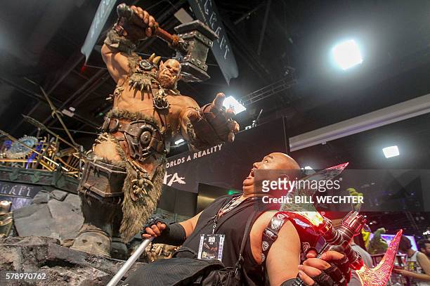 Ed de los Reyes is about to be pummeled by a statue of Orgrim Doomhammer from movie Warcraft during Comic-Con International 2016 in San Diego,...