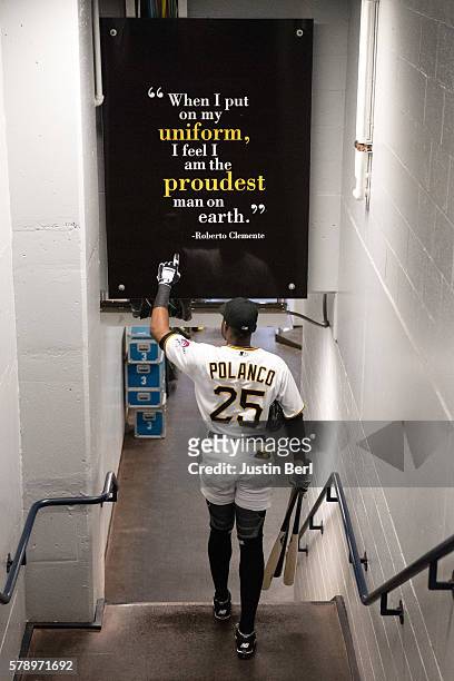 Gregory Polanco of the Pittsburgh Pirates points to a sign honoring Roberto Clemente as he heads towards the dugout before the game against the...