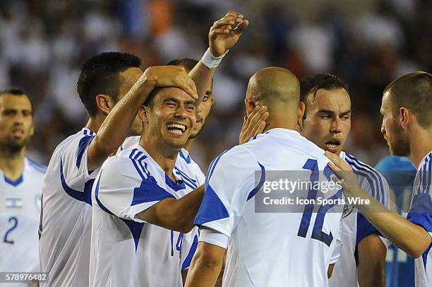 Israel midfielder Neftali Vermouth Gil celebrates with Israel forward Tal Ben Chaim after Chaim's goal during the FIFA international friendly match...