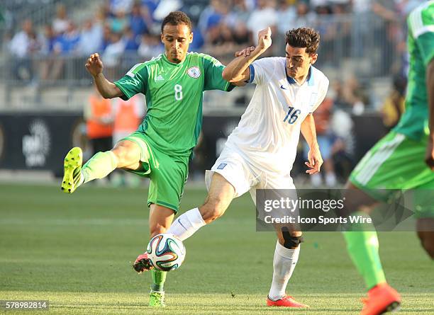 Greek national football team Lazaros Christodoulopoulos and Nigerian national football team Peter Odemwingie compete for the ball during an...