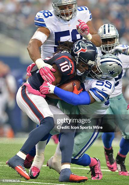 Houston Texans wide receiver DeAndre Hopkins gets tackled by Dallas Cowboys outside linebacker Anthony Hitchens and Dallas Cowboys defensive end Jack...