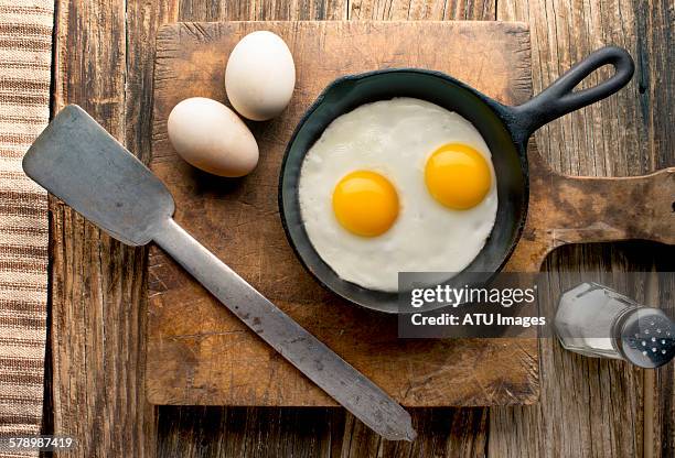 eggs on barnwood - fried egg stock pictures, royalty-free photos & images