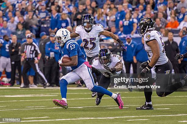 Baltimore Ravens safety Terrence Brooks dives at Indianapolis Colts wide receiver T.Y. Hilton as Baltimore Ravens cornerback Asa Jackson and...