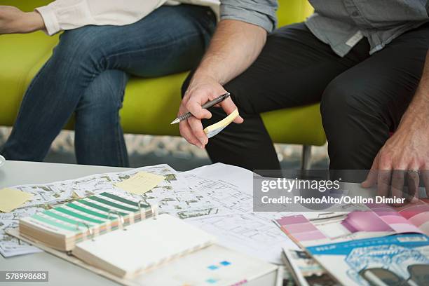 man and woman looking at paint swatches and blueprints, cropped - planalto stock pictures, royalty-free photos & images