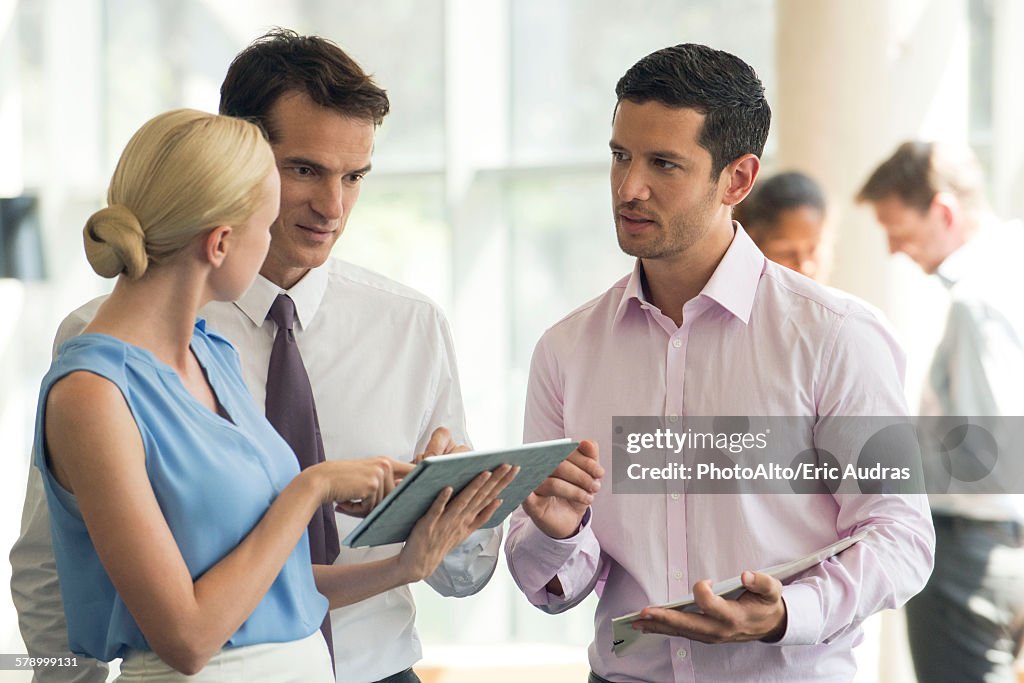 Colleagues collaborating using digital tablet