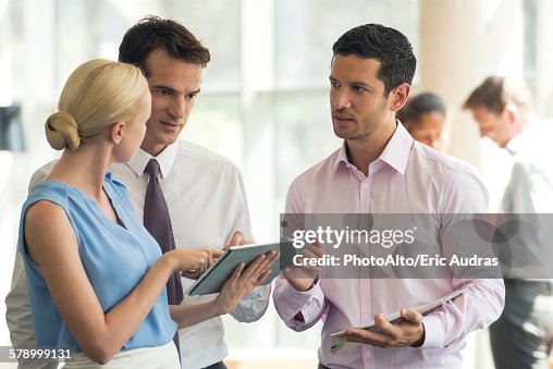Colleagues collaborating using digital tablet Colleagues collaborating using digital tablet
