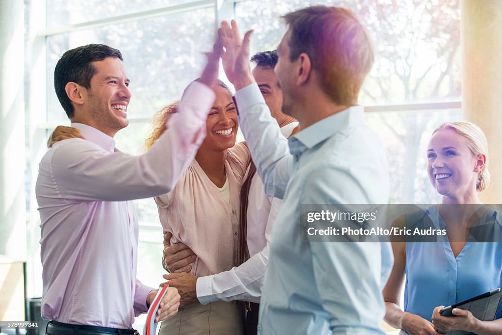 Colleagues giving each other high-five