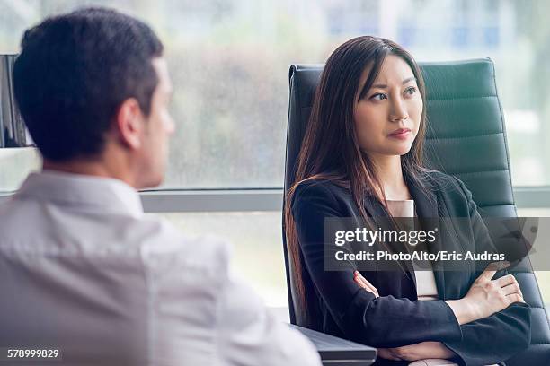 business woman with arms folded looking away with air of disappointment - disappoint bussiness meeting stock pictures, royalty-free photos & images