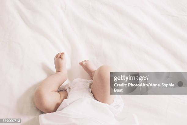 baby lying on bed, cropped - feet of anne stock pictures, royalty-free photos & images
