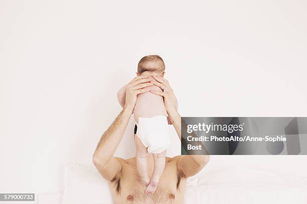 father holding baby - man wearing diaper stock pictures, royalty-free photos & images