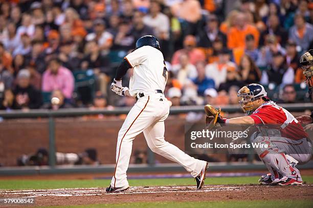 San Francisco Giants left fielder Juan Perez at act and connecting with the ball, during the game between the San Francisco Giants and the Washington...