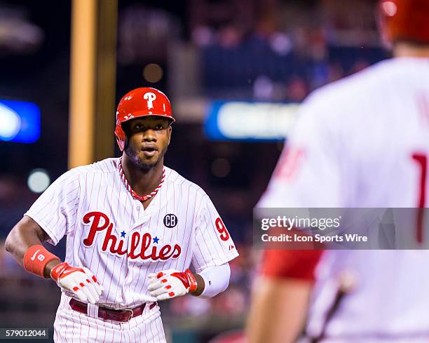 Philadelphia Phillies left fielder Domonic Brown crosses home plate celebrating his home run in the bottom of the seventh inning during a Major...