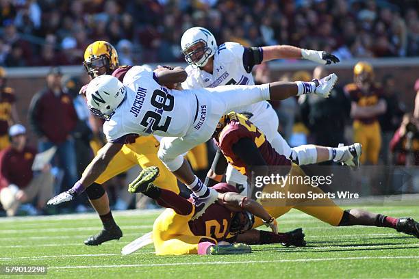 October 11, 2014 Wildcats running back Justin Jackson is up ended by Gophers linebacker Damien Wilson and Gophers defensive back Cedric Thompson...