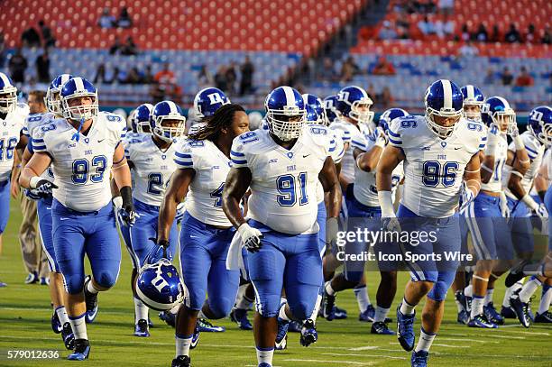 Duke Blue Devils Defensive Tackle Jamal Bruce , Duke Blue Devils Defensive Tackle Allen Jackson , Duke Blue Devils Defensive Tackle A.J. Wolf run off...