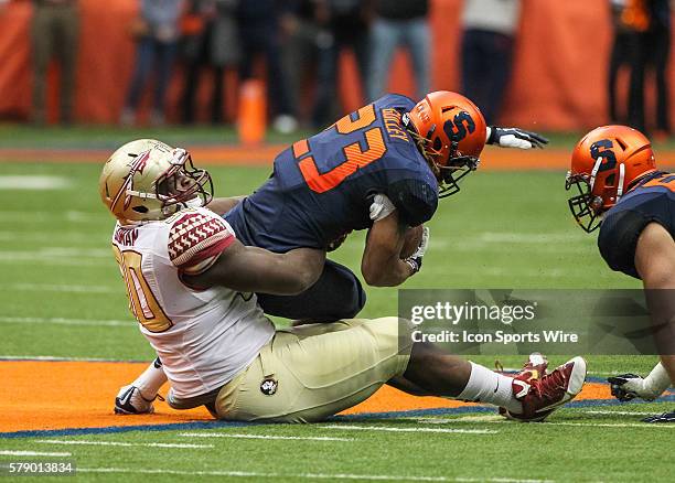 Florida State Seminoles defensive tackle Eddie Goldman tackles Syracuse Orange running back Prince-Tyson Gulley during ncaa football game between...