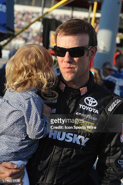 Matt Kenseth Joe Gibbs Racing Home Depot/Husky Toyota Camry holding his daughter before the Sprint Cup Series Toyota Owners 400. Joey Logano Penske...