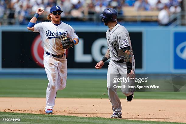 Los Angeles Dodgers second baseman Justin Turner runs down Colorado Rockies right fielder Brandon Barnes during the MLB regular season game between...