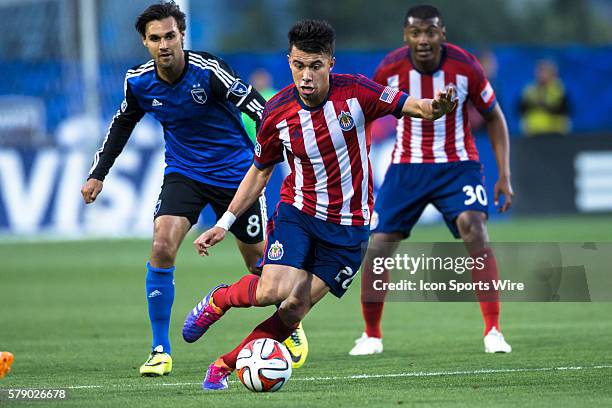 Chivas USA midfielder Carlos Alvarez controls the ba;; as San Jose Earthquakes forward Chris Wondolowski and Chivas USA midfielder Oswaldo Minda...