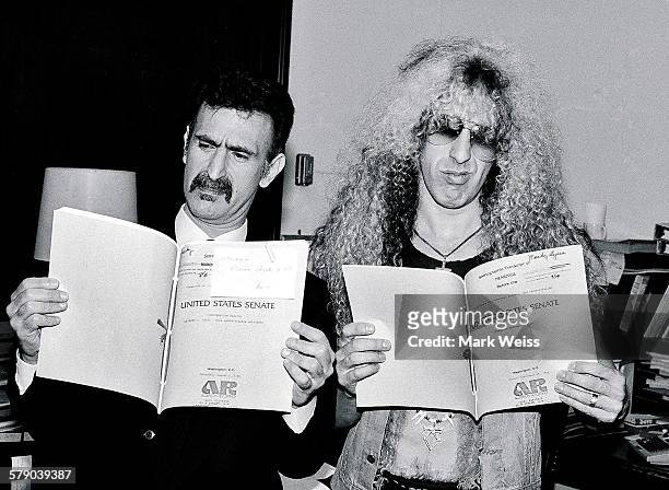 American musicians Dee Snider and Frank Zappa hold up papers relating to the PMRC senate hearing at Capitol Hill, Washington DC, United States, 19th...