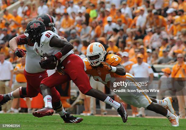 Carl Lee Jr. Arkansas State Red Wolves wide receiver attempts to allude the tackle of Jalen Reeves-Maybin Tennessee Volunteers linebacker during the...