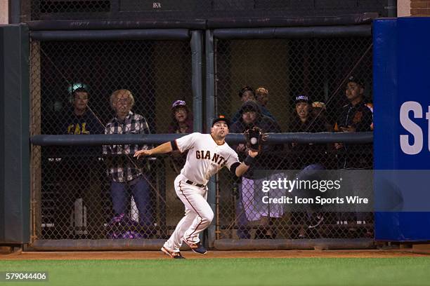 San Francisco Giants left fielder Juan Perez catches a deep fly ball during the game between the San Francisco Giants and the Washington Nationals at...